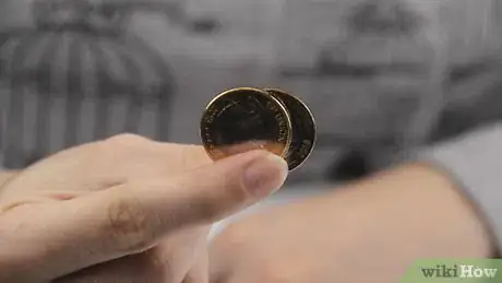 Image titled Make a Coin Go Through Your Hand Step 1