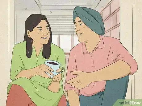 Image titled A couple smiling and having a conversation.