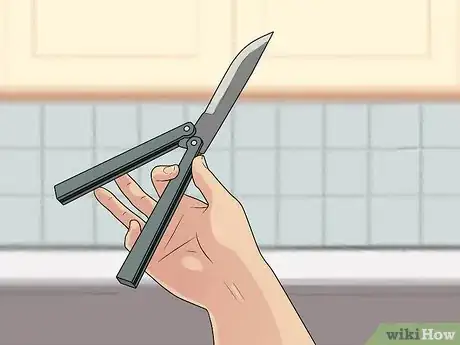 Image titled Perform a Trebuchet with a Butterfly Knife Step 3