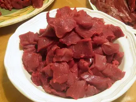 Image titled These pictures show the method using cuts of stew meat. Stew meat and ground meat can be wrapped with this method, but may be initially more difficult than a solid chunk of meat.