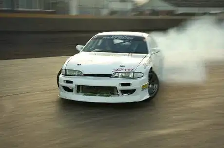 Image titled Lewis Mitchell at the Norfolk Arena. Note that the front of the car seems to be acceptably sharp, but even the windscreen is visibly motion blurred. This is a consequence of trigonometry, not depth of field.