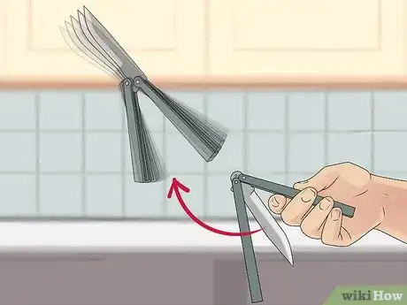 Image titled Perform a Trebuchet with a Butterfly Knife Step 11