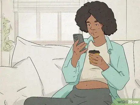 Image titled Woman sitting on her couch having a text conversation.