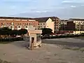 Naval Square is in the background with brick wall behind CHOP prototype of building