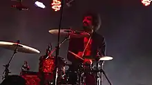 Moretti performing with the Strokes in 2019