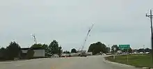 Sign on US 18, SWTC construction in background
