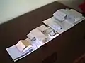 Paper architectural models of  a bungalow, office and  house.