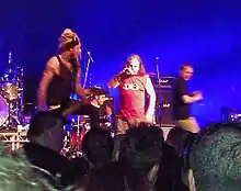 The 2012 incarnation of Pop Will Eat Itself performing live in Birmingham. Left to right: Davey Bennett (bass), Jason Bowld (drums), Graham Crabb (vocals), Mary Byker (vocals)