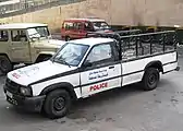 Mazda Courier pickup truck, in the background Toyota Land Cruiser FJ40 Hard Top
