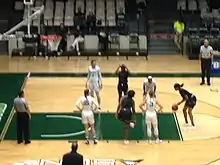 Image 7A player from Webber International (black jersey) attempts a free throw against Stetson University (white jerseys). November 30, 2018. (from Women's basketball)