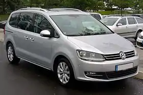 Front three-quarter view of a five-door road car with sliding rear-passenger doors.