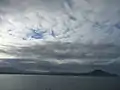 View of the Karitane harbour and seaside on a dark and cloudy day