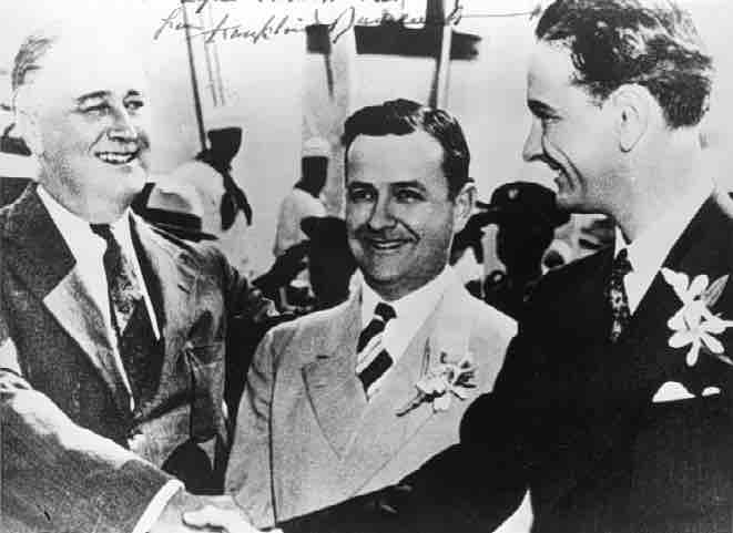 Franklin Delano Roosevelt shakes hands with young Lyndon B. Johnson, Gov. James Allred of Texas in between. Galveston, Texas on May 12, 1937,
Franklin D. Roosevelt