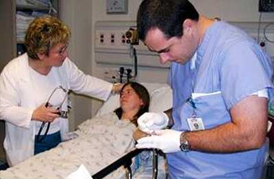 Emergency department staff evaluates a patient with fever who had traveled recently to a malaria-endemic country.