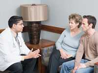 Photo of couple speaking with a doctor Photo of couple speaking with a doctor