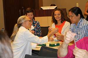 Teachers learning how epidemiology and laboratory science are used to investigate outbreaks.