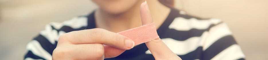 woman putting on a bandaid