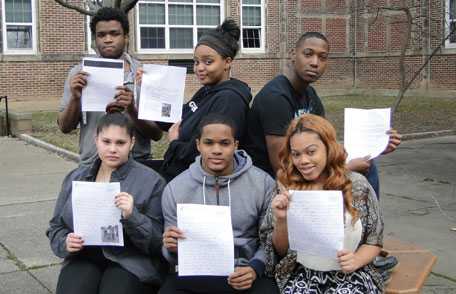 Students holding letters