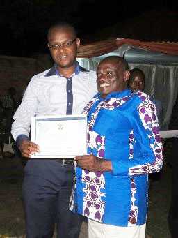 vreceives the Certificate of Appreciation on behalf of CDC Rwanda from Mr. Gaston Rusiha, MP, representing people with disabilities. (Photo courtesy of UPHLS)