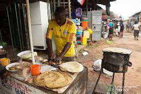 A food vender makes chapatis.