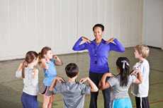 Students exercising between classes with their teacher in a gym
