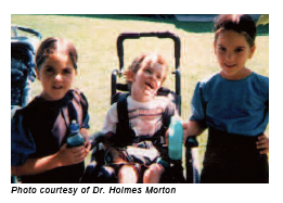Photo of three children diagnosed with glutaric aciduria type I