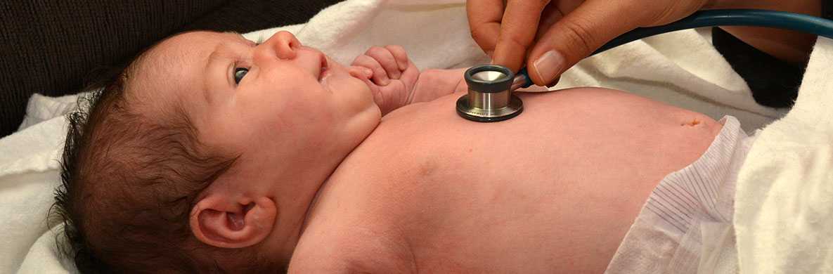Listening to a baby's heart with a stethoscope.
