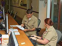 Kevin Chatham-Stephens, MD, MPH (EIS 13) and Ethel Taylor, DVM, MPH (EIS 09 ) review the results of one of 574 telephone questionnaires conducted by CDC staff and Emory volunteers in CDCs Emergency Operations Center during an investigation of illness associated with dietary supplements.