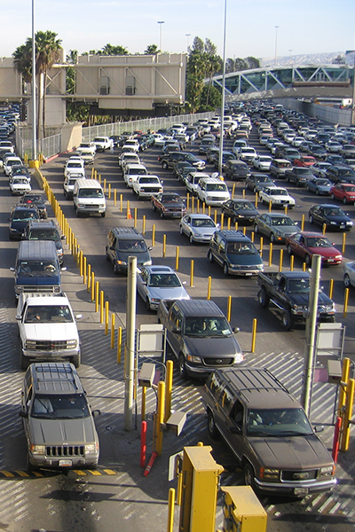 View from pedestrian walkway of cars crossing the United States-Mexico land border.