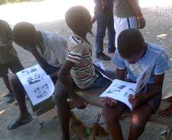 Children read an informational comic book that teaches lessons on rabies.