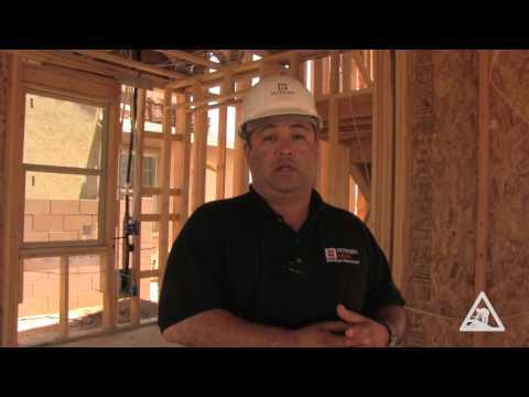 Construction worker inside a wood building frame