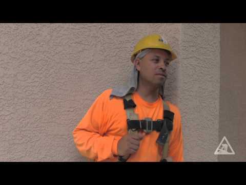 Construction worker in a safety harness