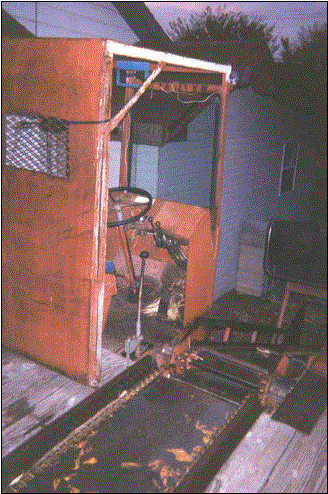 image shows the cab area and the conveyor belt on the hay truck