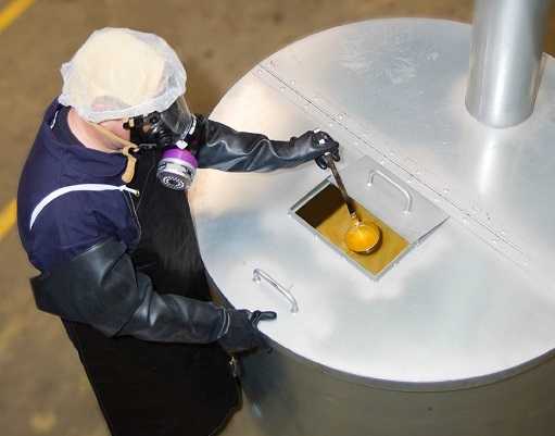 worker retrieving diacetyl from a large cistern
