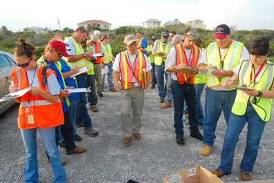Oil spill cleanup workers filling out paperwork
