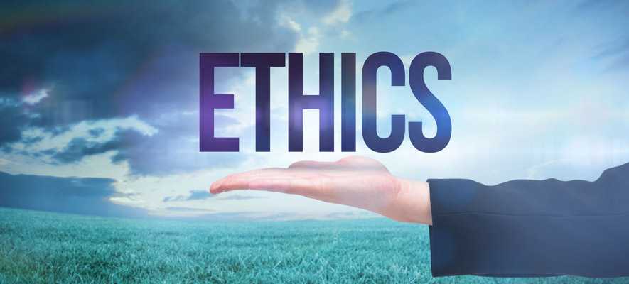 Woman's hand holding ethics sign