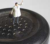 Photo: Picture of a doctor on top of phone. Studio shot of concept of house calls by doctor