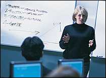 PHPR Training: a woman is talking in front of a group PHPR Training: a woman is talking in front of a group